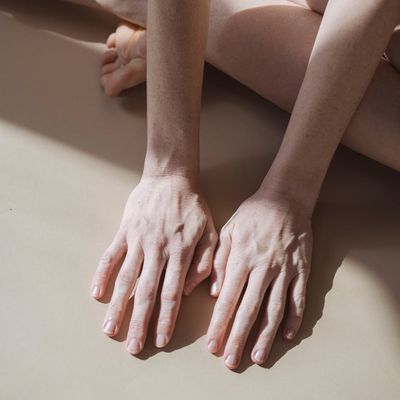 Close-up of hands in a mindful, gentle pose.